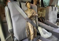 Borlaug statue buckled into car seat 