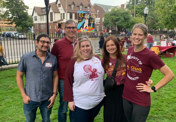 Robert, Brian, Diane, Becky, and Zoe at the CFANS sampler outside Folwell hall wearing UMN maroon.